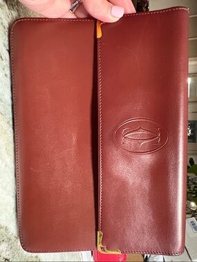 Cartier Burgundy Leather clutch with pull out strap and Gold Plaque